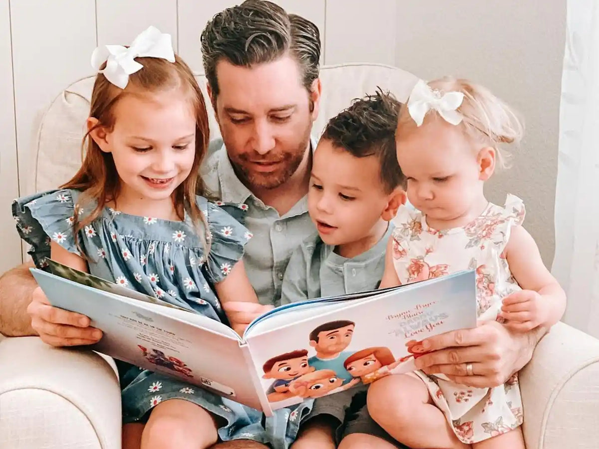 Un padre sosteniendo su libro personalizado de Hurra Héroes.